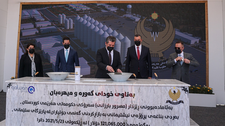 Kurdistan Region Prime Minister Masrour Barzani (center) lays the foundation stone of a wheat marketing project in Sulaimani province, May 23, 2021. (Photo: KRG)